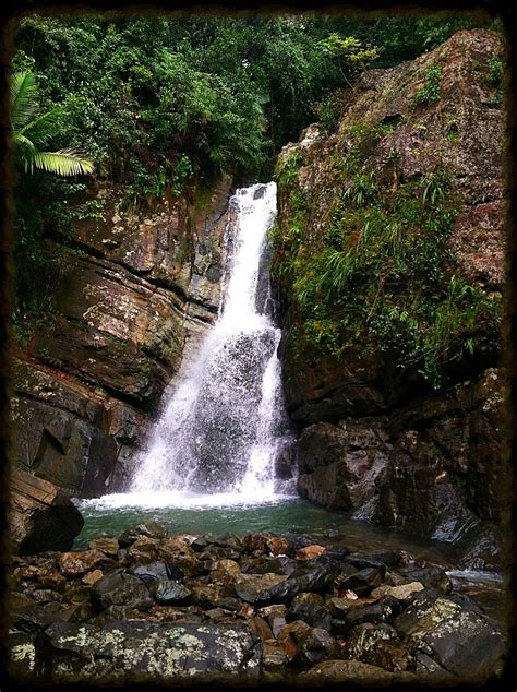 there is a waterfall in the middle of some rocks