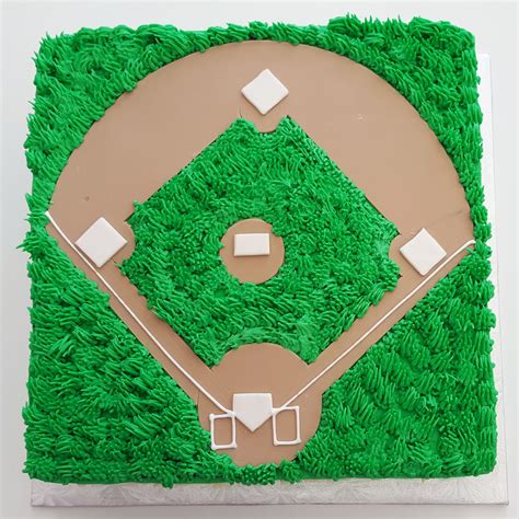 a cake shaped like a baseball field on top of green frosting with white squares