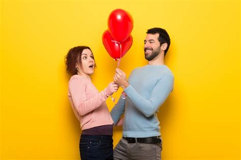 Premium Photo | Couple in valentine day with balloons with heart shape