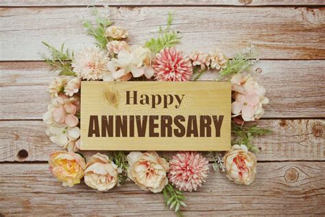 Happy Anniversary Text with Flowers Frame Decorate on Wooden Background ...