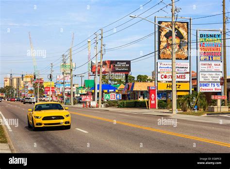 Yellow Ford Mustang travelling along International Drive, Orlando, Florida, USA Stock Photo - Alamy