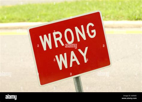 Horizontal color image of a wrong way sign along a public road or ...