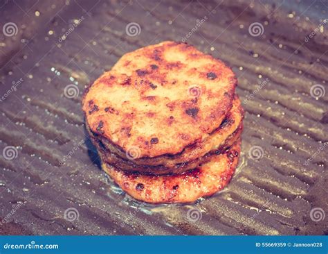 Hamburgers in a grill pan stock image. Image of delicious - 55669359