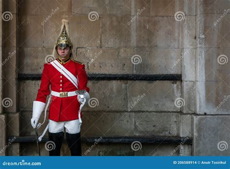 A Young Queen`s Life Guard in Full Uniform with Royal Red Coat and ...