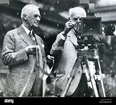 Thomas Alva Edison (right), one of the pioneers in motion pictures, and ...