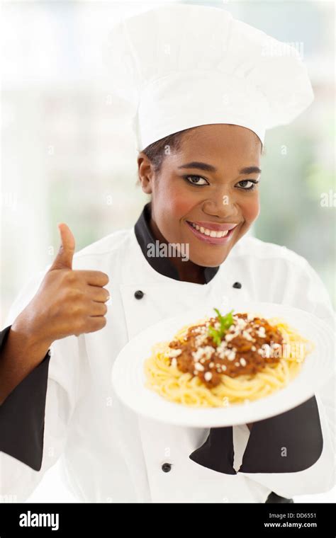 smiling female African American chef giving thumb up Stock Photo - Alamy