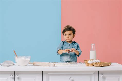 Cute Little Boy At White Kitchen Table Free Stock Photo and Image