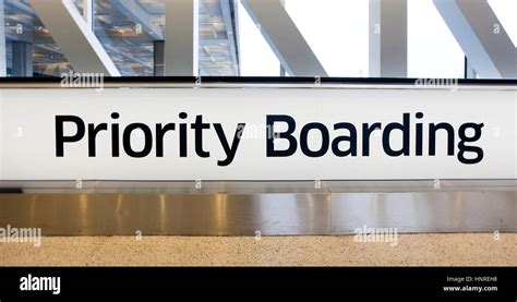 Airport PRIORITY BOARDING sign Stock Photo - Alamy