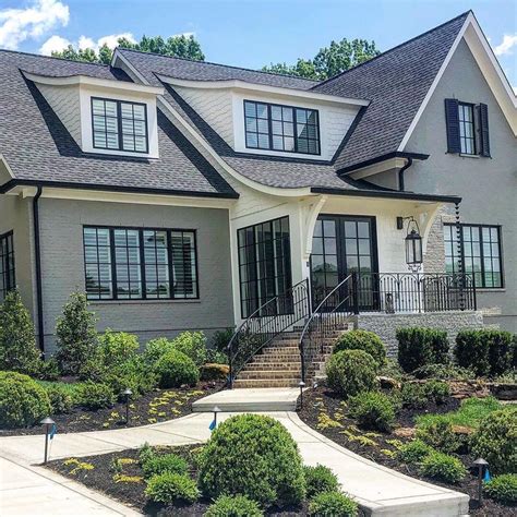 Gray painted brick with black windows and look at that roof line ... 🤩 ...