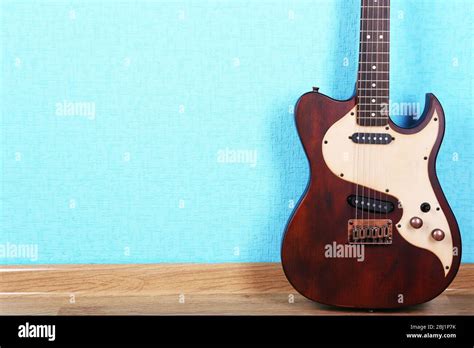 Electric guitar on blue wallpaper background Stock Photo - Alamy