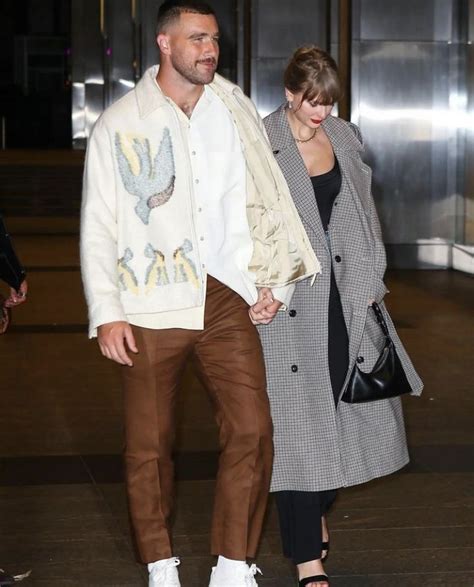 a man and woman are walking together in an airport holding hands while ...