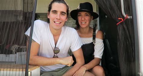 a man and woman sitting in the back of a bus