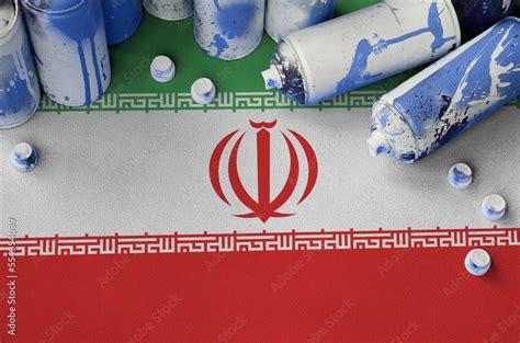 Iran flag and few used aerosol spray cans for graffiti painting. Street ...