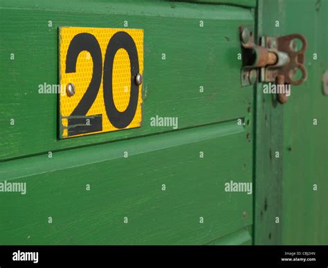 Black on yellow number twenty 20 on a dark green South Coast beach hut Stock Photo - Alamy