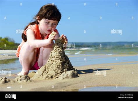 Kids on the beach, Young Girl Playing In The Sand, to make sandcastles ...