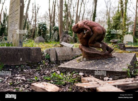 Sculpture of a man pushing a boulder up hill like Sisyphus at Highgate Cemetery Stock Photo - Alamy