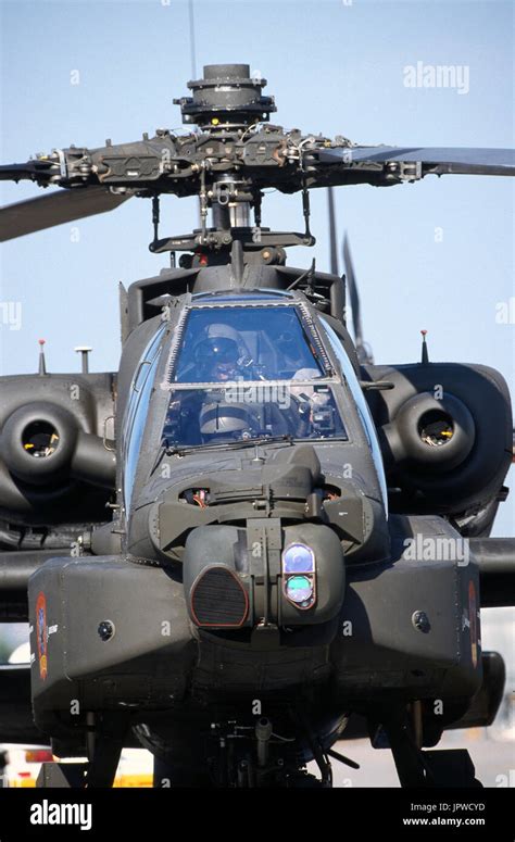 pilot in the cockpit of a US Army Boeing AH-64 Apache preparing to take ...