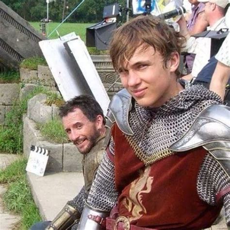 two men dressed in medieval armor posing for the camera