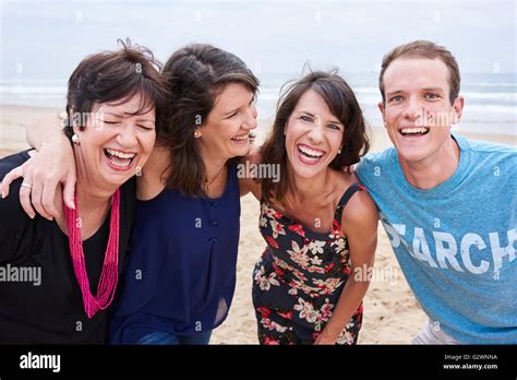 Family laughing and having fun on the beach together Stock Photo - Alamy