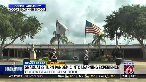 Cocoa Beach high school seniors cross bridge during graduation ceremony