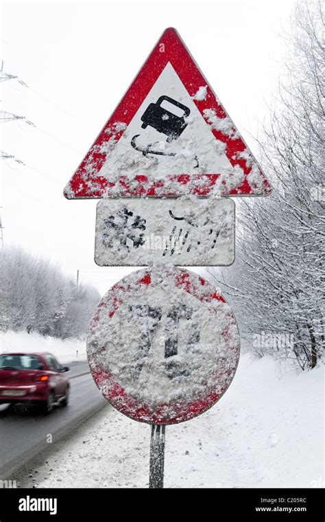 Snowy road signs skidding in winter Stock Photo - Alamy