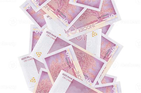 10 Estonian kroon bills flying down isolated on white. Many banknotes ...