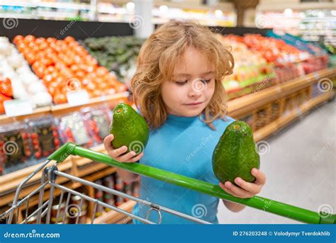 Portrait of Child with Shopping Cart Full of Fresh Vegetables in a Food ...