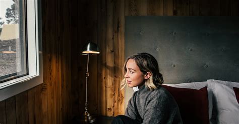 Thoughtful woman on bed putting on shoes · Free Stock Photo