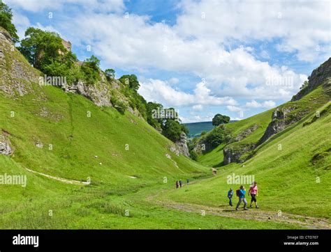 Hikers walking up Cave dale in Castleton Derbyshire Peak district national park England UK GB EU ...