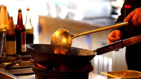 A Man Who is Cooking in a Wok Stock Photo - Image of flaming, food: 188792714