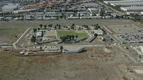 8K stock footage aerial video approaching the California Institution for Men prison in Chino ...