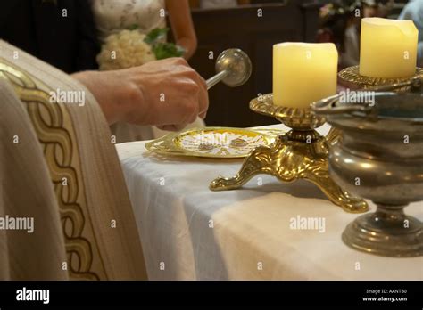 priest blessing wedding rings Stock Photo - Alamy