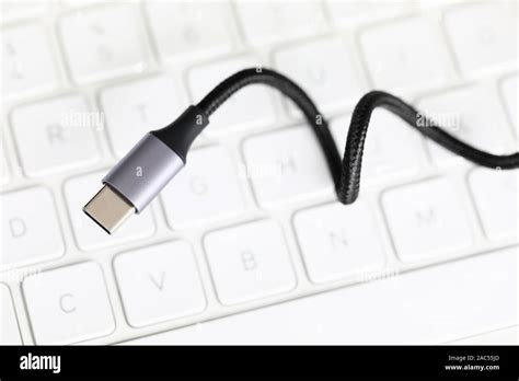Usb type c cable against laptop keyboard background Stock Photo - Alamy