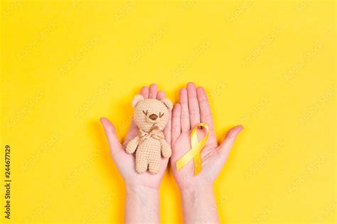 Girl hands holding children's toy with a Childhood Cancer Awareness ...