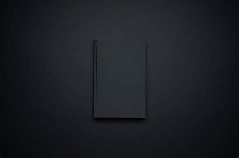 Premium Photo | Mockup of blank black book template isolated on black background for your design