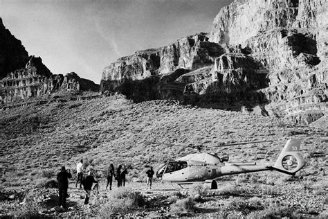 passengers leaving on helicopter tour landed on pad down in the Grand canyon Arizona USA ...