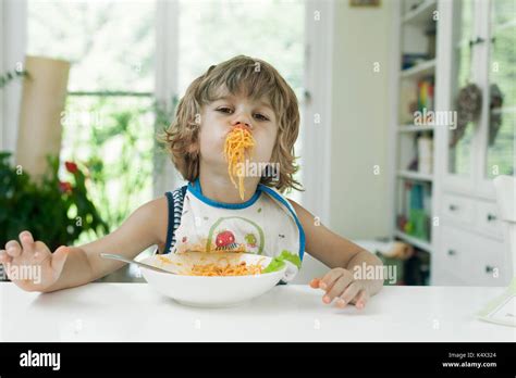 Portrait messy boy eating spaghetti hi-res stock photography and images ...