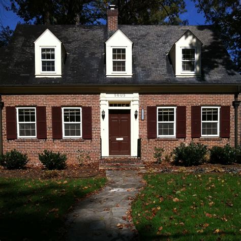 I love the uniformity of this house. The red door, red shutters and white upper windows and ...