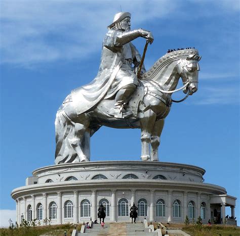 a statue of a man on a horse in front of a building with steps leading up to it