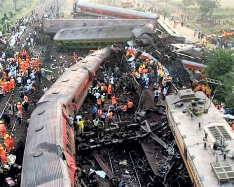 Rescuers try to raise buried coach at triple rail crash site as death toll is 238