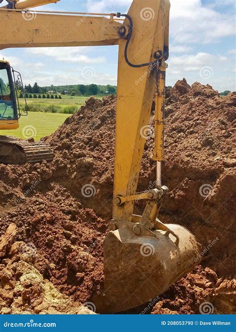 Backhoe digging a hole stock photo. Image of hydraulics - 208053790