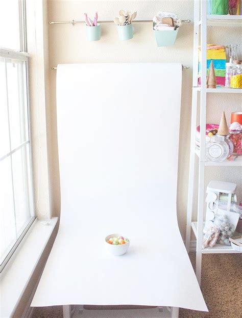 Love this idea for blog photography backgrounds! Get a large roll of white paper & hang it on a ...