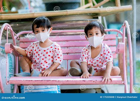 Child Wearing a Protective Face Mask on a City Street with Air ...