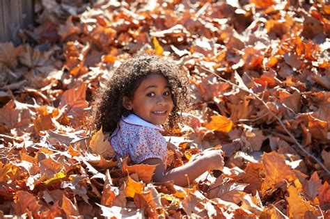 Premium Photo | Toddler kid girl playing with autumn leaves