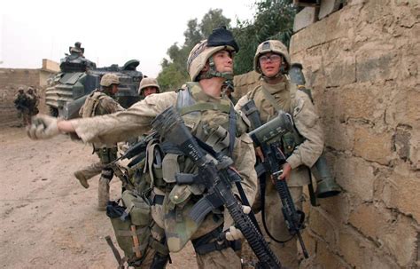 Marine tossing a fragmentation grenade over a wall in Fallujah, Iraq | American soldiers, Us ...