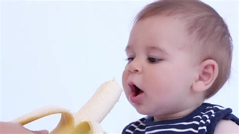 Baby Boy Is Eating A Banana N A White Background Stock Footage Video 6729217 - Shutterstock