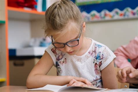 Free Photo | Blonde girl in glasses reading