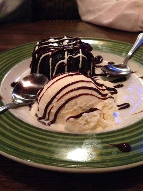 a green and white plate topped with ice cream covered in chocolate ...