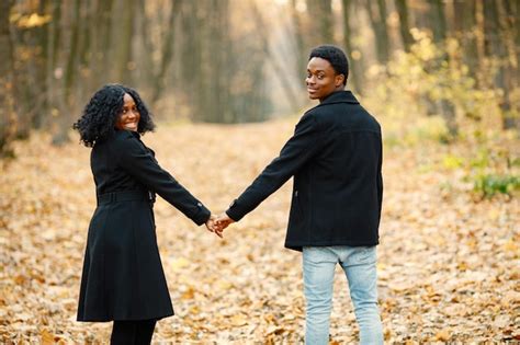 Free Photo | Black young man and his girlfriend holding hands. Romantic couple walking in autumn ...