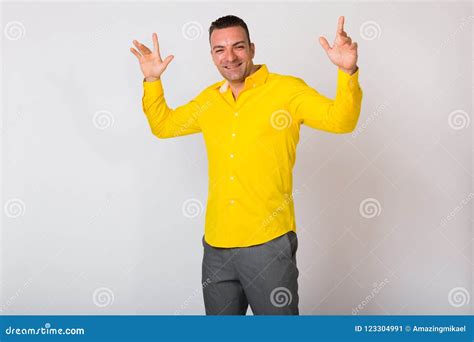 Portrait of Man Wearing Yellow Shirt Against White Background Stock ...